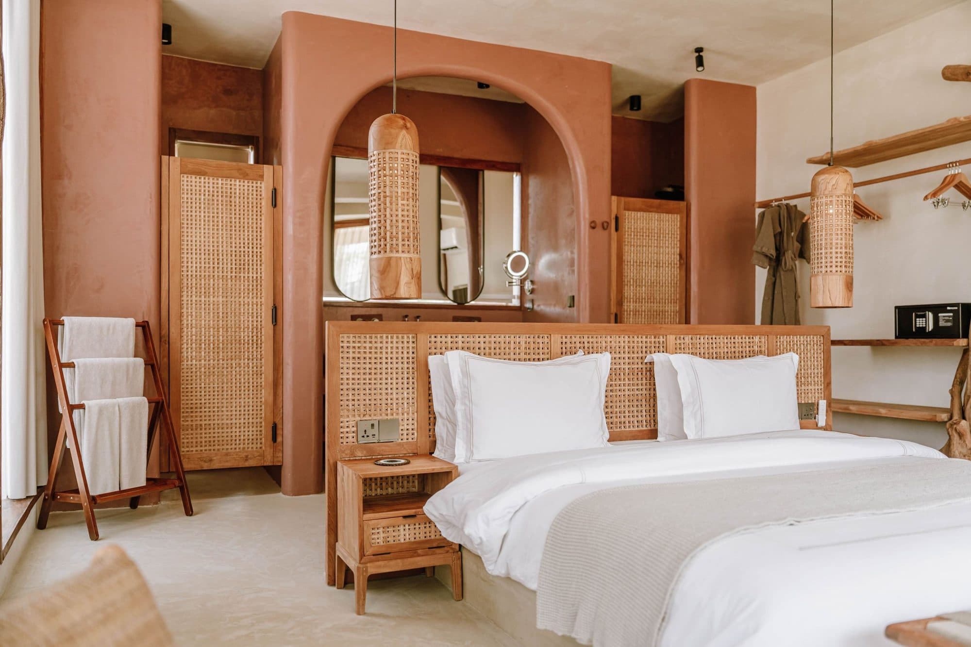Vanity mirror and rattan details in a hotel bathroom nook