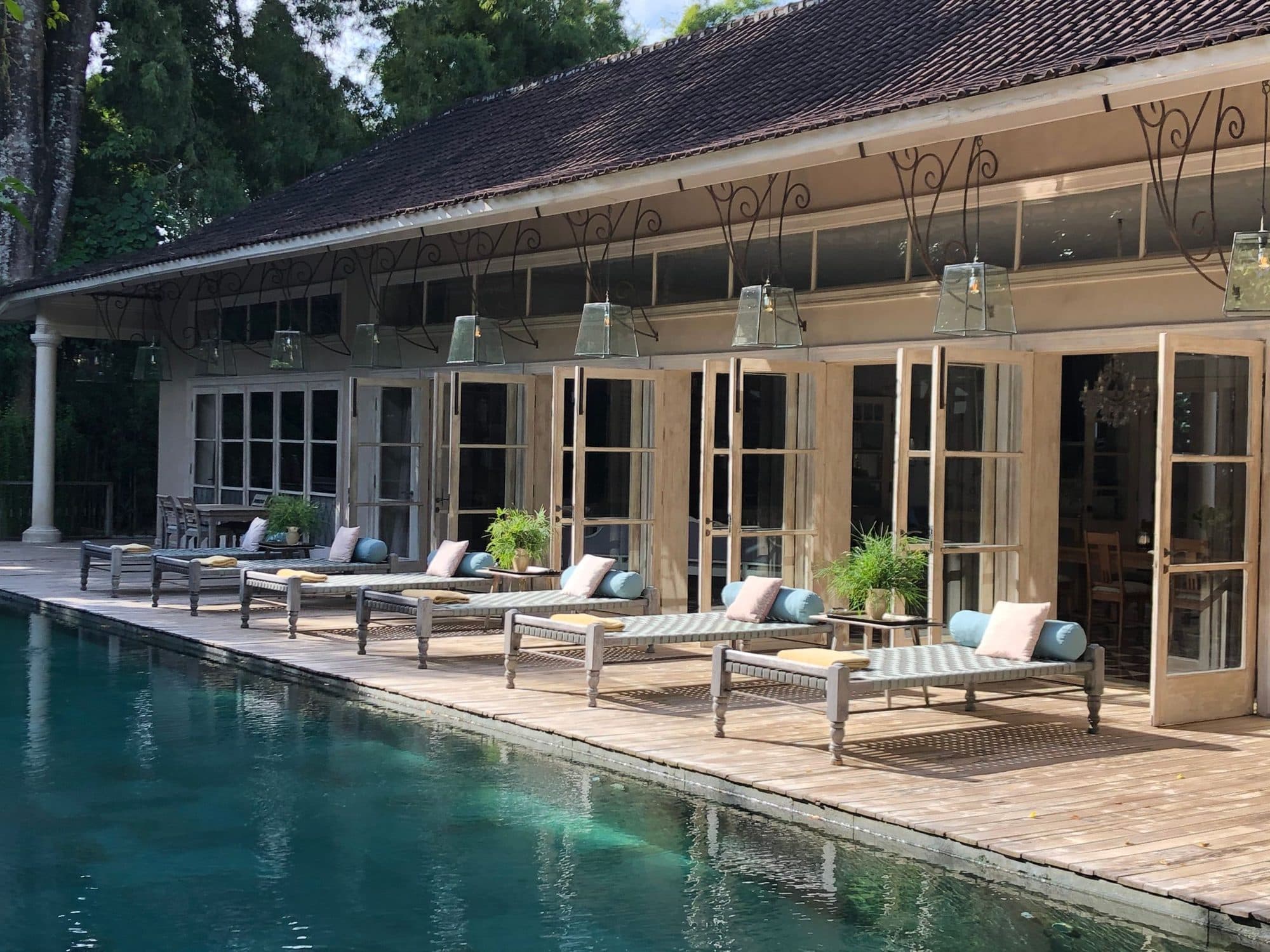 Poolside view at a luxury villa in Bali with loungers