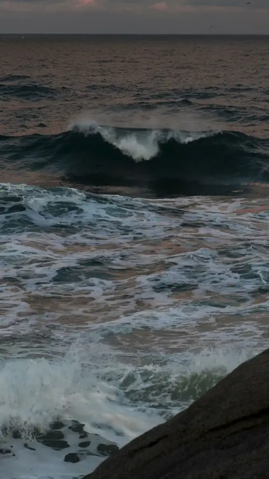 Waves rolling in at dusk